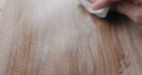 woodworker applying oil finish to black walnut board