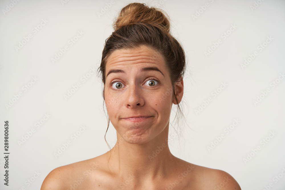 Close-up of attractive young woman posing over white background with ...