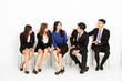 © Tom Wang - happy asian business people sitting on the chairs in a row