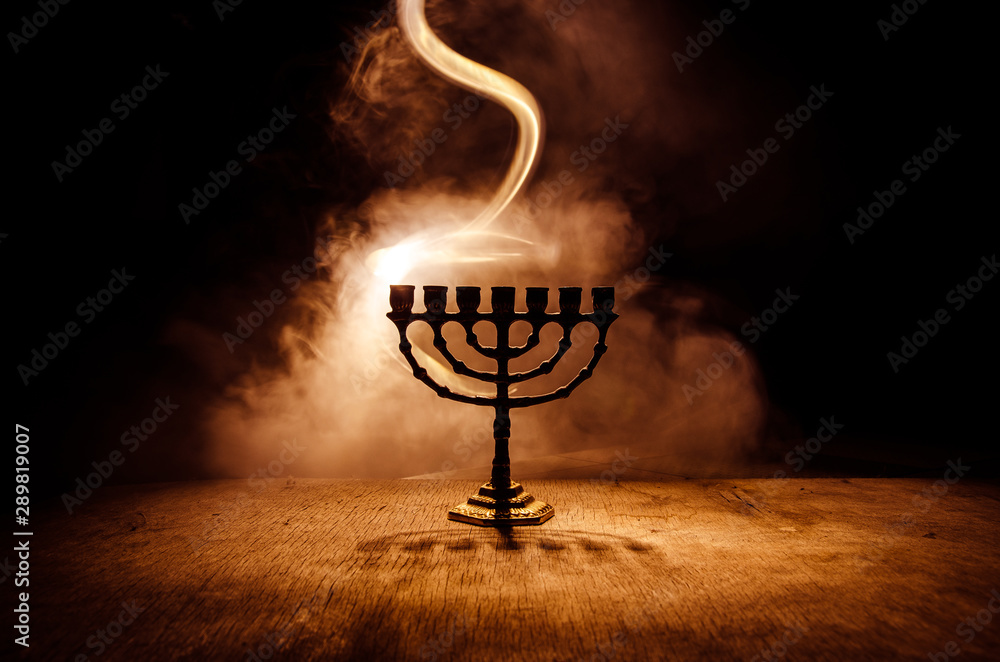 Obraz na płótnie Low key image of jewish holiday Hanukkah background with menorah on dark toned foggy background w salonie