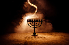 Low Key Image Of Jewish Holiday Hanukkah Background With Menorah On Dark Toned Foggy Background