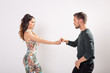 © satura_ - Passionate couple dancing social danse kizomba or bachata or semba or taraxia on white background with copy space