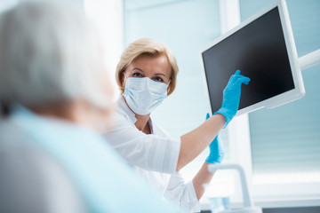 Wall Mural - Dentist pointing a finger at the monitor screen