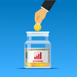 hand putting coin in dividend jar,investment concept.