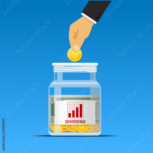 Cuadros en Lienzo hand putting coin in dividend jar,investment concept.