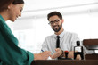© New Africa - Male notary working with client in office