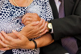 Fototapeta  - Dłonie pary staruszków, którzy się przytulają, dłonie z obrączkami na palcach, gest miłości