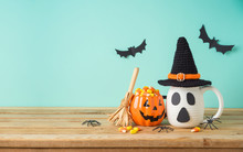 Halloween Holiday Concept With Jack O Lantern Cup, Candy Corn, Witch Hat And Decorations On Wooden Table