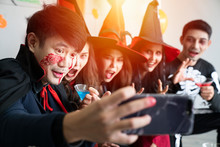 Young Asian People, A Group Of Five Persons, In Scary Costumes Selfie Their Own Photo. Group Of Friends Having Fun At A Party In A Nightclub To Celebrate Halloween Festival.