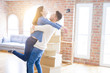 © Krakenimages.com - Beautiful young asian couple hugging in love, smiling happy and very excited for moving to a new home