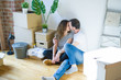 © Krakenimages.com - Middle age senior romantic couple in love sitting on the apartment floor with cardboard boxes around and smiling happy for moving to a new home