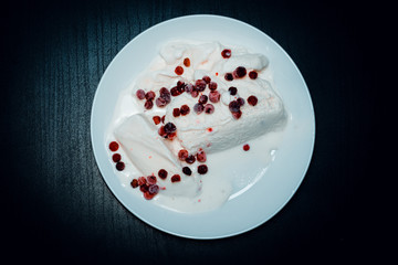 Wall Mural - Ice cream on a white plate on dark wood