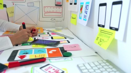 Wall Mural - web designer is developing an application for mobile phones. creating a layout of the user interface