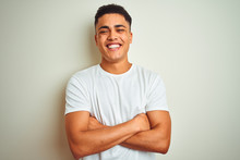 Young Brazilian Man Wearing T-shirt Standing Over Isolated White Background Happy Face Smiling With Crossed Arms Looking At The Camera. Positive Person.