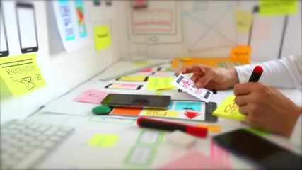Wall Mural - web designer is developing an application for mobile phones. creating a layout of the user interface