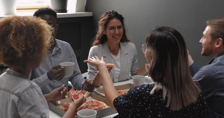 Wall Mural - Happy relaxed multiracial business team people laughing eating takeaway pizza