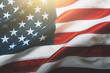 Leinwandbild Motiv USA flag background. Waving American flag in sunlight flare, close up