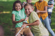 © LIGHTFIELD STUDIOS - selective focus of happy children competing in tug of war