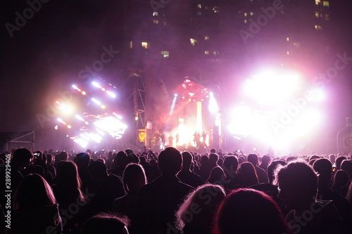 Fotomural Kiev, Ukraine, Europe - September 15, 2019: Many spectators in front of the stage waving their hands