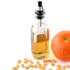 Wall Mural - Pumpkin seed oil isolated on white background. Free space for your text.