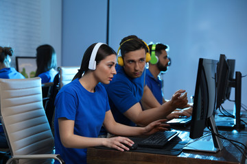 Canvas Print - Young people playing video games on computers indoors. Esports tournament