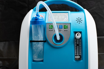 Medical Device Individual Blue White portable oxygen cylinder to put gas for patients with respiratory disorders, studio lighting black background