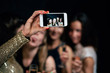 Women night out concept, hen party, celebration. Group of girls drinking champagne, taking selfie in night club.