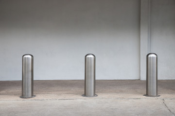 steel bollards on concrete pavement.