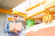 © Monster Ztudio - Young asian engineers are working on the construction site. Wear a yellow helmet safety. Hand holding computer laptop