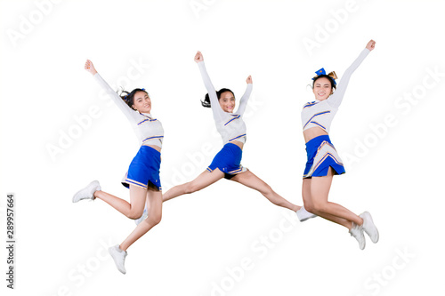 Cuadros en Lienzo Group of cheerleader girls jumping together on studio