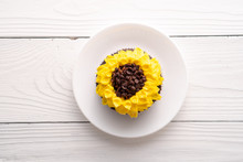 Beautiful Sunflower Decorated Chocolate Cupcake On White Wood Background