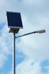 Pillar with electric solar panel and street lighting lamp system. Modern street equipment with renewable energy save technology.