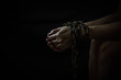 © isara - Close up of woman hands bondage with old rusty metal chain in the dark room, Conceptual image sex abuse and Slave trade prevention concept with copy space.