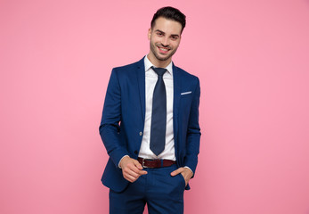 Canvas Print - attractive young man wearing navy blue suit on pink bakground