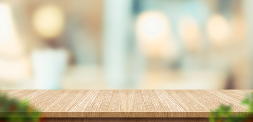 Aufkleber - wood table and blurred leaf foreground in restaurant with bokeh background. product display template.Business presentation