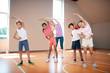© zinkevych - Pupils and PE teacher working on flexibility before starting PE lesson