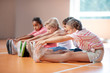 © zinkevych - Boys and girl reaching for toes while stretching their bodies