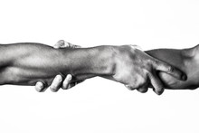 Close Up Help Hand. Two Hands, Helping Arm Of A Friend, Teamwork. Helping Hand Concept And International Day Of Peace, Support. Helping Hand Outstretched, Isolated Arm, Salvation. Black And White