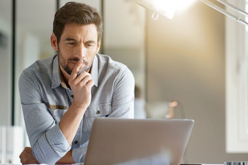 Wall Mural - Modern man working in office