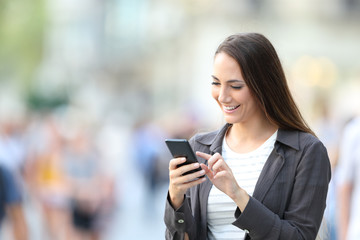 Wall Mural - Happy casual woman checking smart phone content