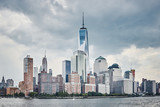 Fototapeta Miasta - Manhattan skyline with stormy sky seen from the river, color toning applied, NYC.