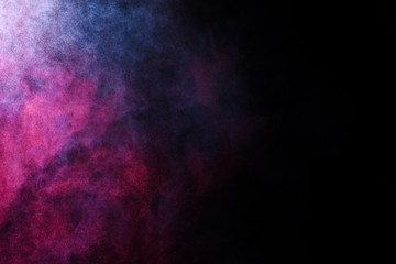Wall Mural - freeze motion of colored dust explosion isolated on black background.