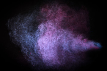 Wall Mural - freeze motion of colored dust explosion isolated on black background.