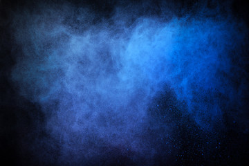 Wall Mural - Freeze motion of colored dust explosion isolated on black background.