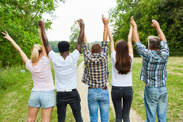 Wall Mural - Young people cheer together in the park