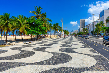 Fototapete - View of Copacabana beach with palms and mosaic of sidewalk in Rio de Janeiro, Brazil. Copacabana beach is the most famous beach in Rio de Janeiro. Sunny cityscape of Rio de Janeiro