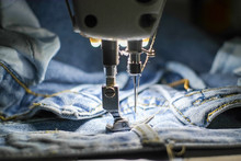 Blue Jeans With White Industrial Sewing Machine.