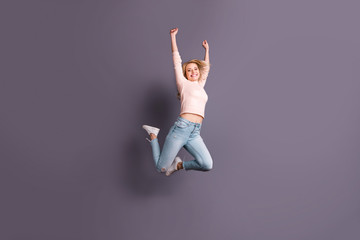 Sticker - Full length photo of pretty lady jumping high competitive sporty mood raising hands up wear casual stylish outfit isolated grey color background