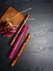 Wall Mural - Fruit pastille on wooden background. Fruit roll-ups made from raspberry, apples, oplum, currant, strawberry