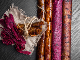 Wall Mural - fruit and berries pastille with linen thread on a wooden background close up